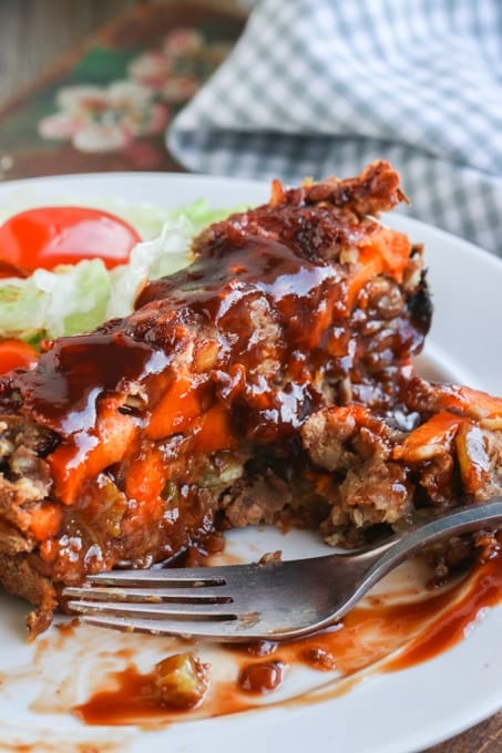 Picture of eaten slice of vegan lentil loaf on white plate