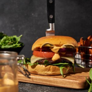 Portobello mushroom burger with all the trimmings on a dark table