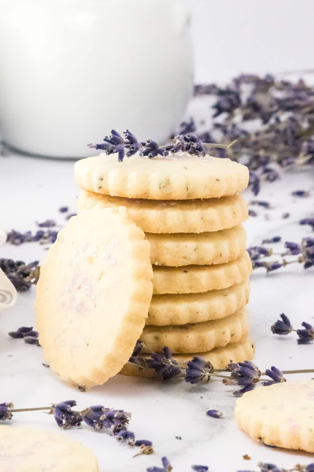 a stack of lavender shortbread cookies on a marble table