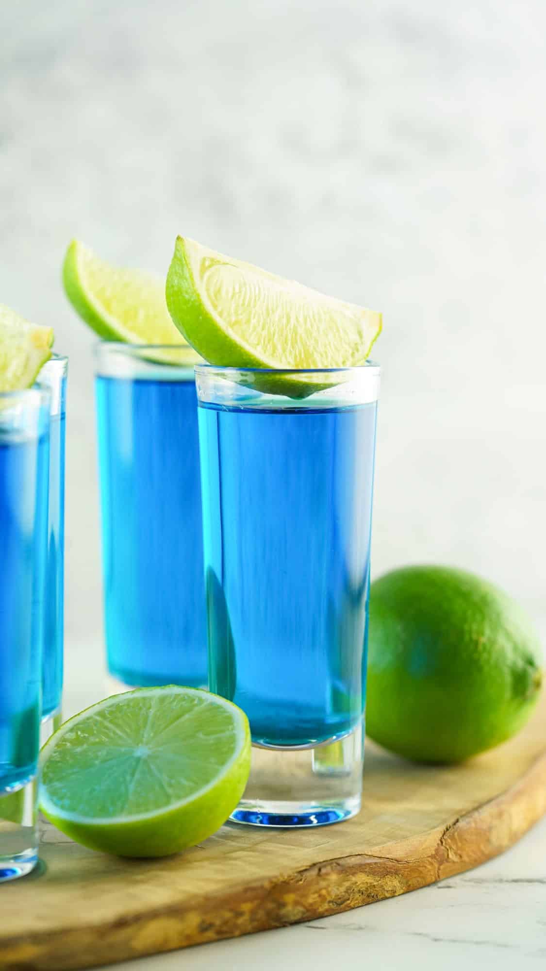 straight on view of blue kamikaze shots in clear shot glasses