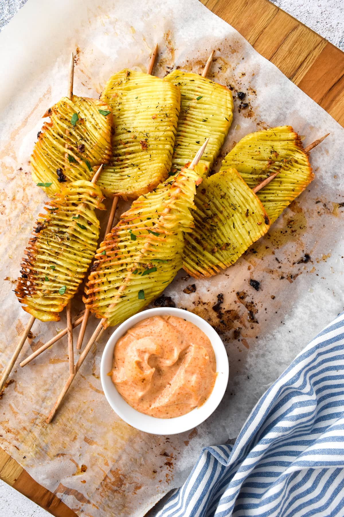 accordion potatoes on a wood cutting board