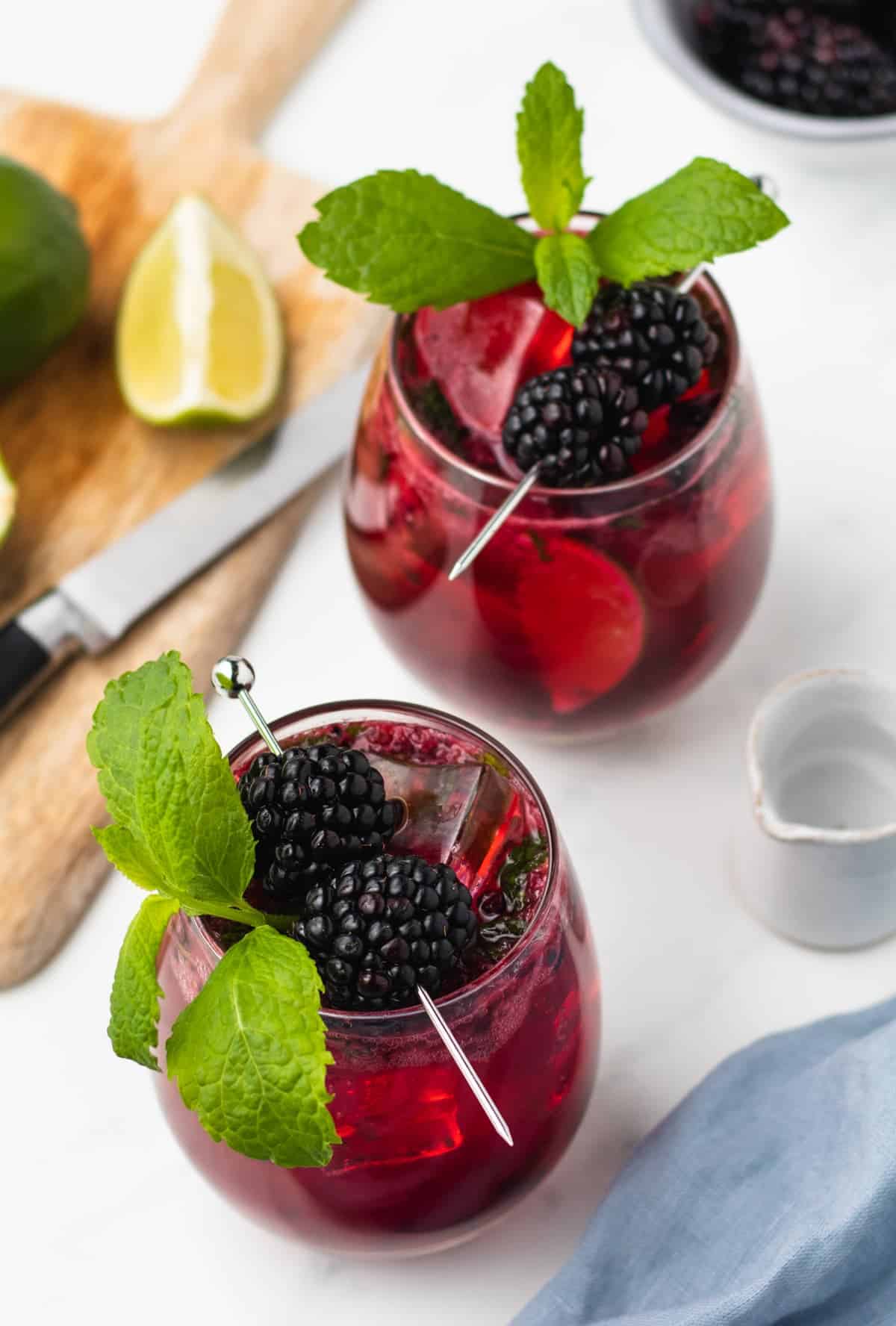 overhead of 2 blackberry mojito cocktails