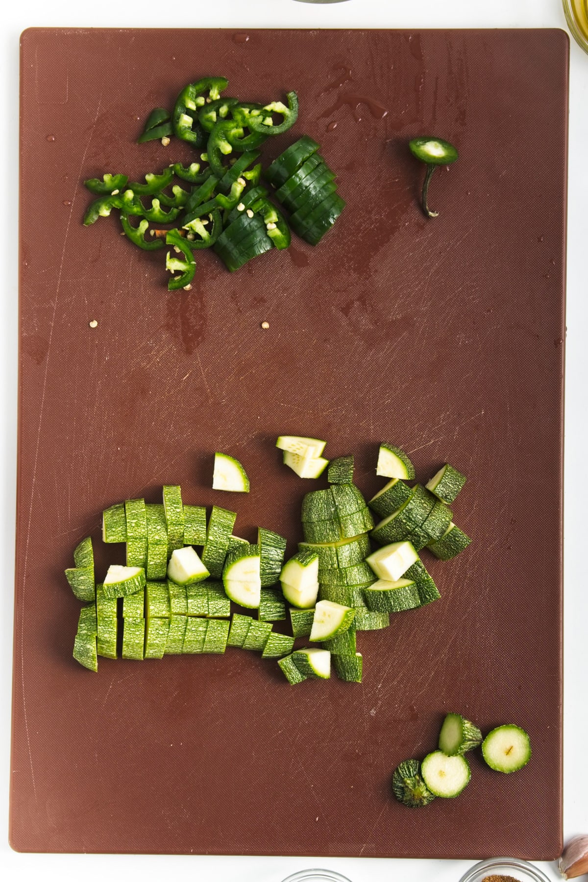 chopped green vegetables on a brown cutting board