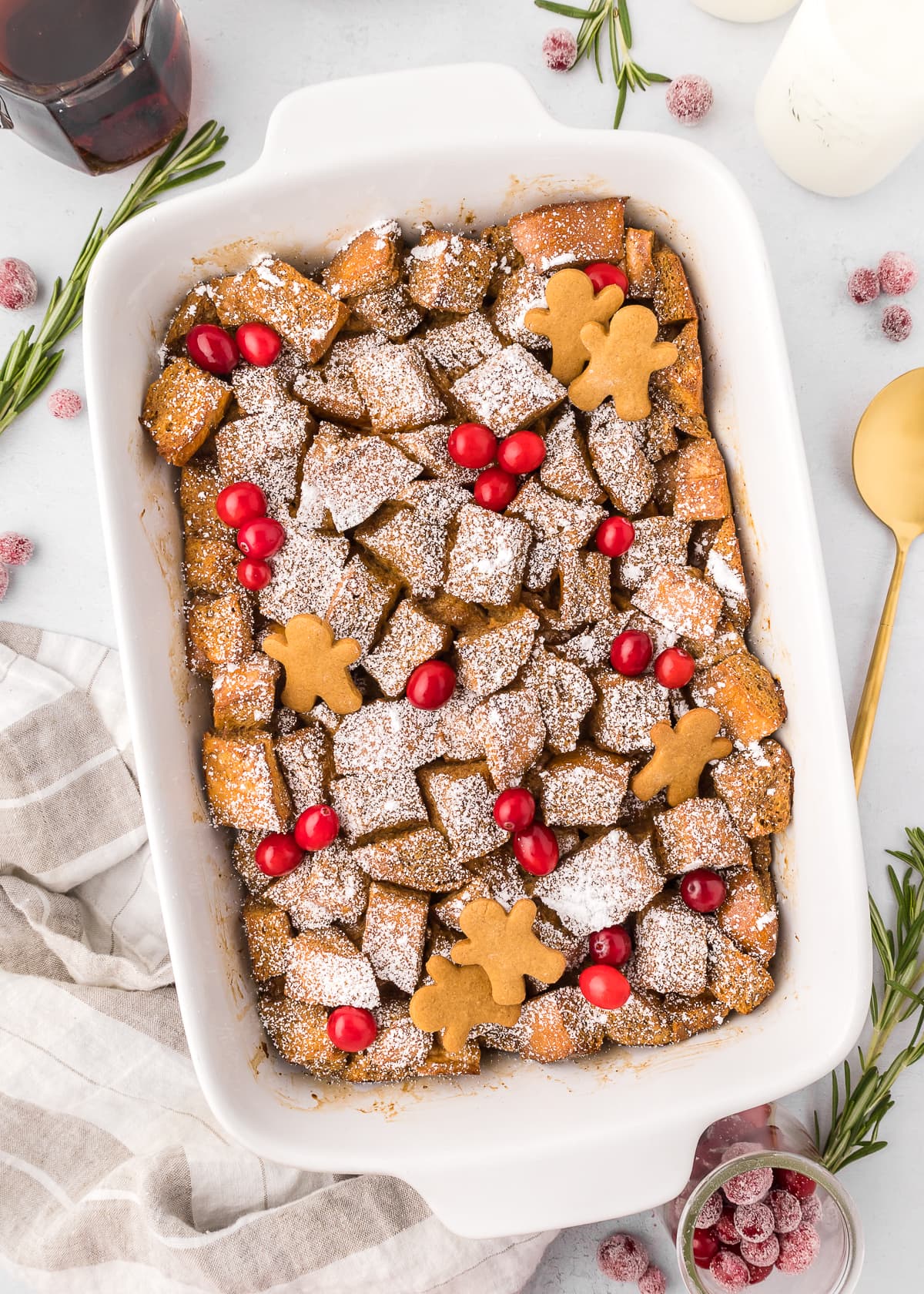 garnished gingerbread french toast casserole in a white casserole dish. 