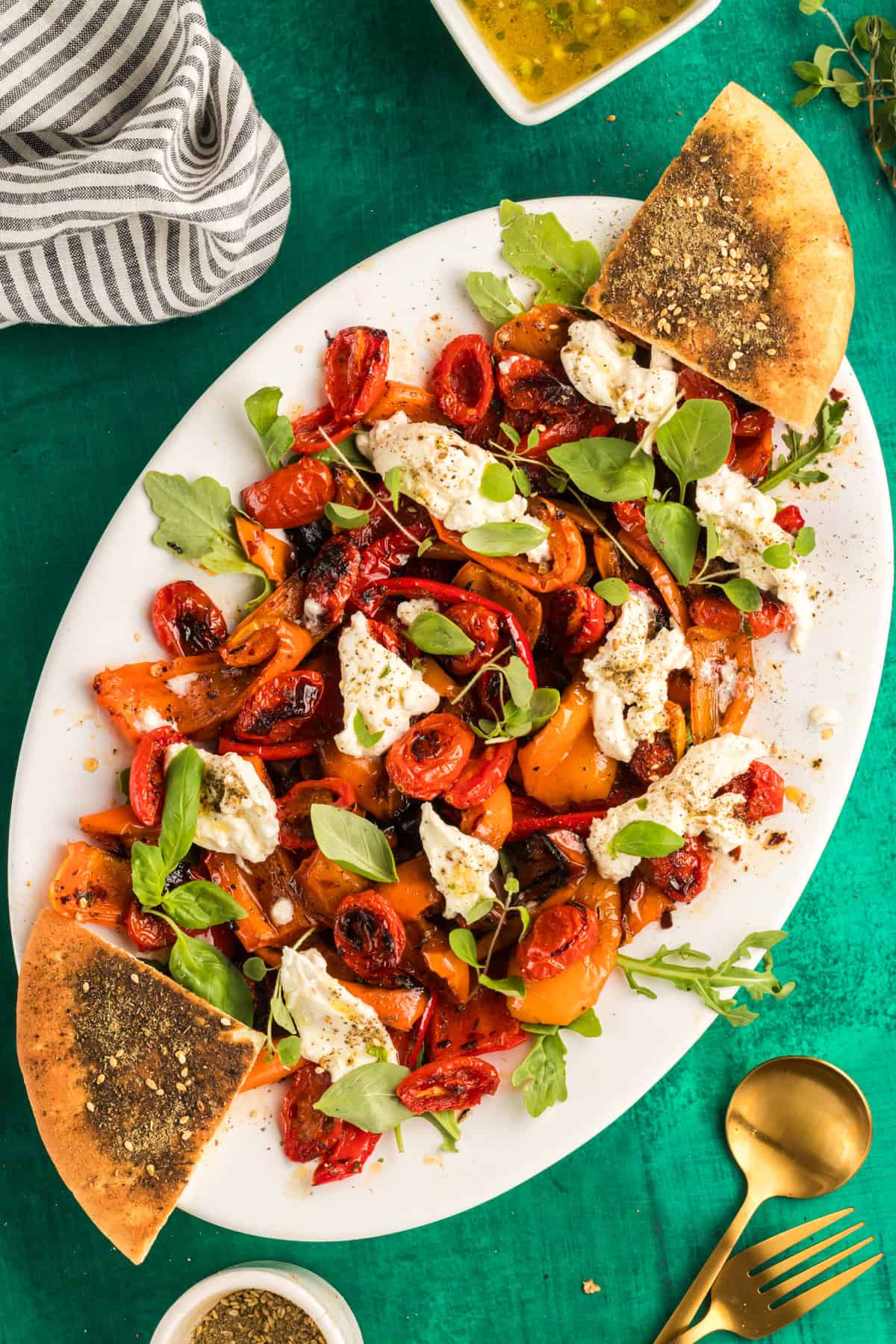 bell pepper salad on a white platter with zaatar pita chips